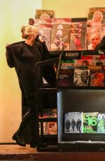MILEY CYRUS Checks Herself on the Cover of a Magazine at a Newsstand in Los Angeles 11/13/2021