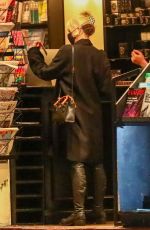 MILEY CYRUS Checks Herself on the Cover of a Magazine at a Newsstand in Los Angeles 11/13/2021