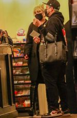 MILEY CYRUS Checks Herself on the Cover of a Magazine at a Newsstand in Los Angeles 11/13/2021