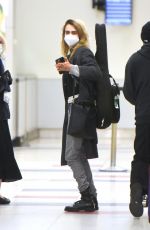 SIENNA MILLER and CARA DELEVINGNE at JFK Airport in New York 12/30/2021