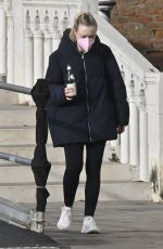 DAKOTA FANNING Holding a Bottle of Wine Out in Venice 01/22/2022