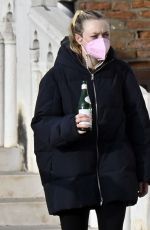 DAKOTA FANNING Holding a Bottle of Wine Out in Venice 01/22/2022