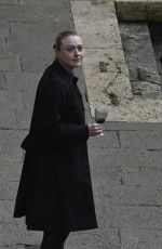 DAKOTA FANNING Enjoys a Glass of Red Wine in Venice 02/05/2022