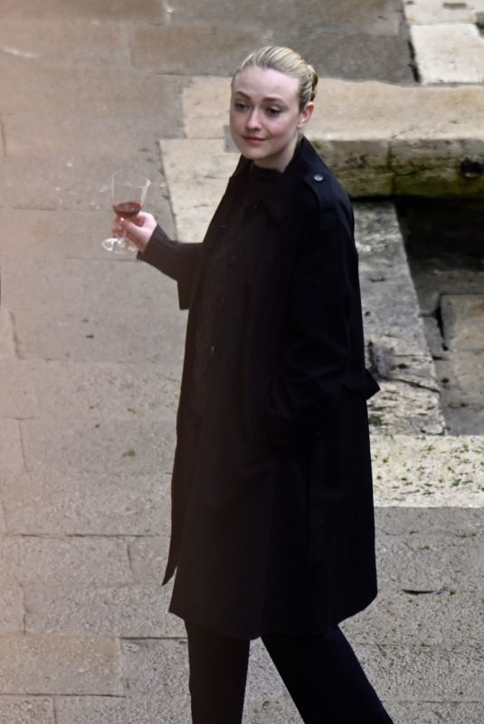 DAKOTA FANNING Enjoys a Glass of Red Wine in Venice 02/05/2022