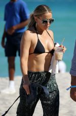 KATE HUDSON in a Black Bikini at a Beach in Miami 02/27/2022