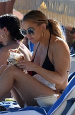 KATE HUDSON in a Black Bikini at a Beach in Miami 02/27/2022