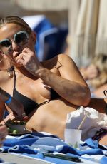 KATE HUDSON in a Black Bikini at a Beach in Miami 02/27/2022