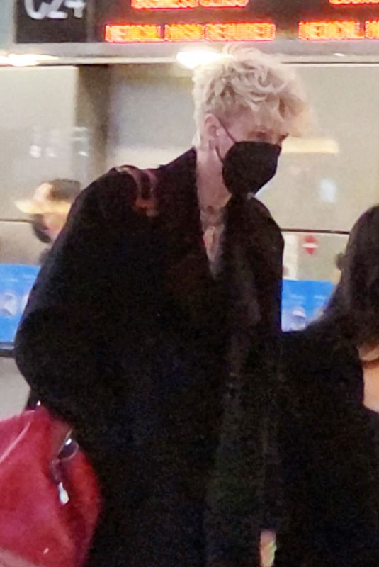 MEGAN FOX and Machine Gun Kelly at LAX Airport in Los Angeles 02/11/2022