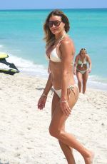 KELLY BENSIMON in a White Bikini on the Beach in Miami 03/17/2022