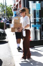 LUCY HALE Picks up a Load of Packages at UPS in Los Angeles 03/16/2022