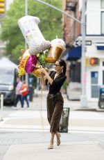 BELLA HADID Out Picks up Some Balloons in New York 05/20/2022