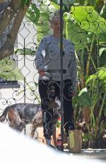ERIKA JAYNE Picks up a Flower Delivery Outside Her Home in Los Angeles 05/11/2022