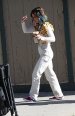 LUCY HALE Riding a Bike on a Movie Set in Los Angeles 05/08/2022