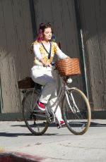 LUCY HALE Riding a Bike on a Movie Set in Los Angeles 05/08/2022