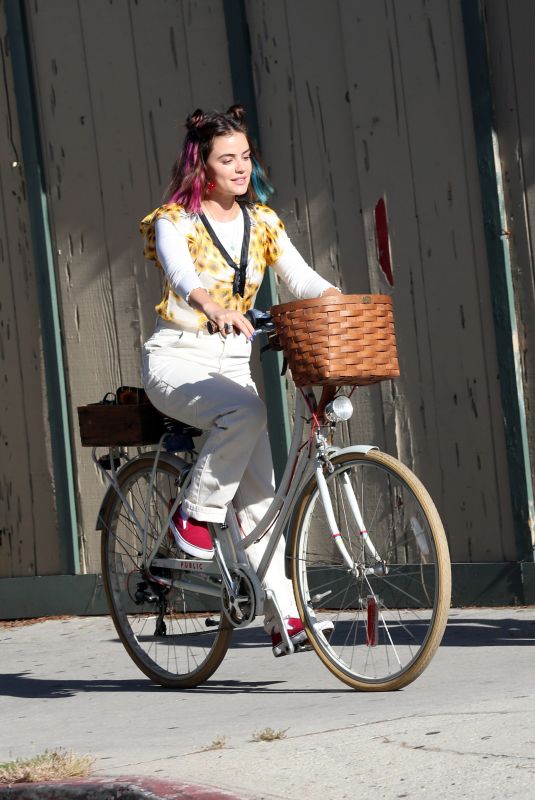 LUCY HALE Riding a Bike on a Movie Set in Los Angeles 05/08/2022