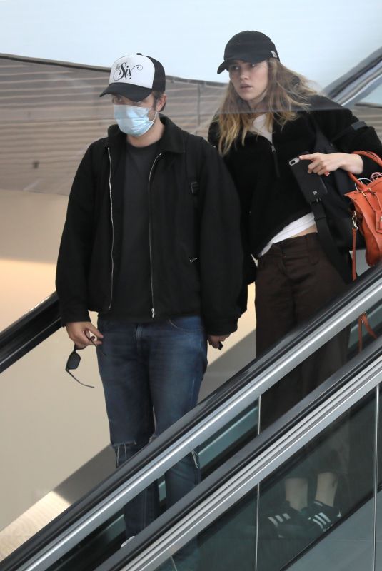 SUKI WATERHOUSE and Robert Pattinson at LAX Airport in Los Angeles 05/16/2022