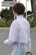 MAISIE WILLIAMS Out Trying to Hide Her Cigarette in Cannes 06/21/2022