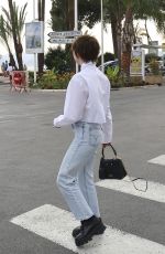 MAISIE WILLIAMS Out Trying to Hide Her Cigarette in Cannes 06/21/2022