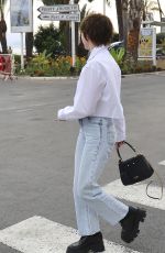 MAISIE WILLIAMS Out Trying to Hide Her Cigarette in Cannes 06/21/2022