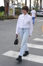 MAISIE WILLIAMS Out Trying to Hide Her Cigarette in Cannes 06/21/2022