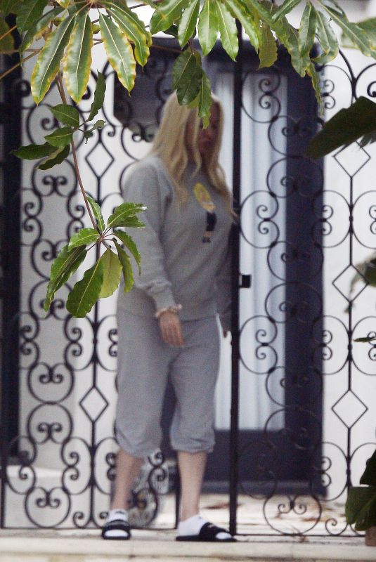ERIKA JAYNE Gets a Starbucks Coffee Bag Delivered at Her Home in Los Angeles 07/14/2022
