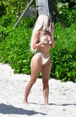 KIM and KHLOE KARDASHIAN in Metallic Bikinis at a Beach in Turks and Caicos 07/09/2022