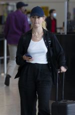 LILY JAMES Arrives at Heathrow Airport in London 08/03/2022