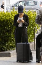 LILY JAMES Arrives at Heathrow Airport in London 08/03/2022