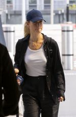 LILY JAMES Arrives at Heathrow Airport in London 08/03/2022