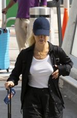 LILY JAMES Arrives at Heathrow Airport in London 08/03/2022