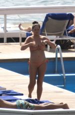 Pregnant CHRISSY TEIGEN in Bikini at a Pool at Lake Como 08/28/2022