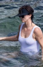 CHARLIZE THERON in a White Swimsuit on Holiday in Tuscany 09/05/2022