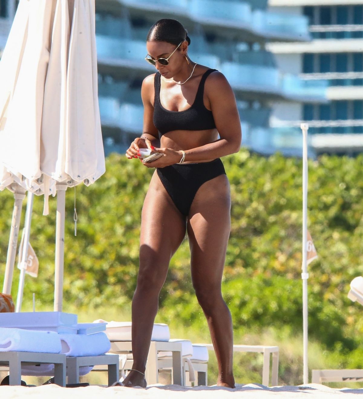 KELLY ROWLAND in Bikini at a Beach in Miami 09/01/2022.