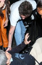 NICOLA PELTZ and Brooklyn Beckham Help an a Photographer at a Vogue Runway Show in New York 09/12/2022