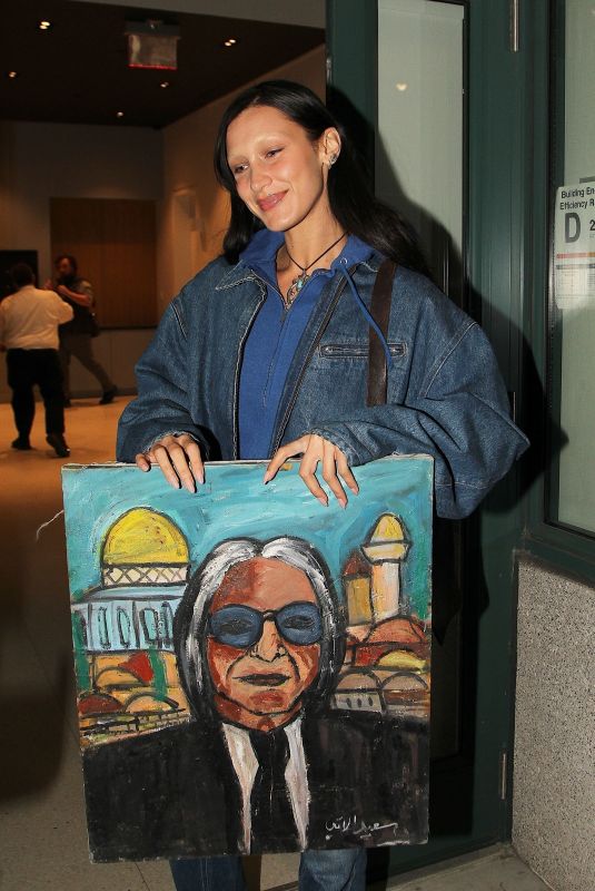 BELLA HADID Receives a Painting of Her Dad while Out in New York 10/10/2022