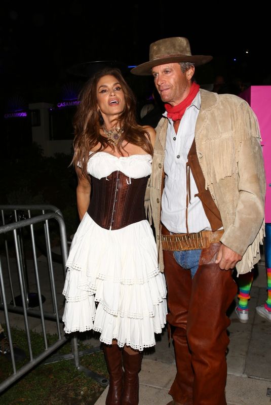 CINDY CRAWFORD and Rande Gerber Arrives at Casamigos Halloween Party in Beverly Hills 10/28/2022