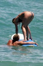JENNIFER ANISTON in Bikini Takes Surf Lessons in Hawaii 08/23/2007