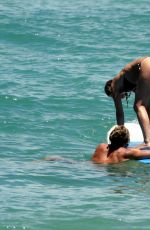 JENNIFER ANISTON in Bikini Takes Surf Lessons in Hawaii 08/23/2007
