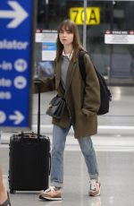LILY COLLINS and Charlie McDowell at LAX Airport in Los Angeles 10/27/2022