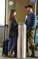 LILY COLLINS and Charlie McDowell at LAX Airport in Los Angeles 10/27/2022