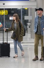LILY COLLINS and Charlie McDowell at LAX Airport in Los Angeles 10/27/2022