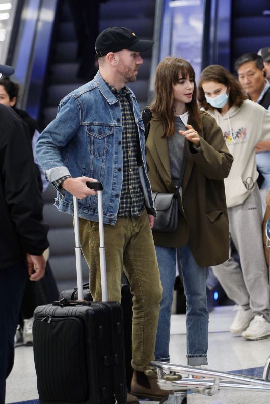 LILY COLLINS and Charlie McDowell at LAX Airport in Los Angeles 10/27/2022