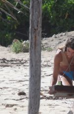 CLARA BERRY in Bikini Picking the Trash from the Beach in Tulum 11/19/2022