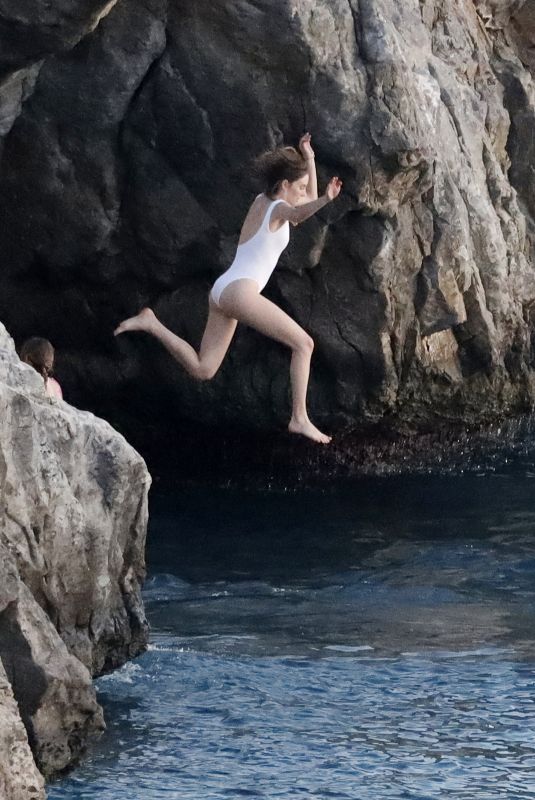 MAYA HAWKE in White Swimsuit Jumping into the Sea in St Barts 12/28/2022