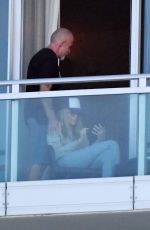 TISH CYRUS and Dominic Purcell  on Their Balcony in Miami 12/31/2022