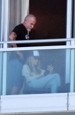 TISH CYRUS and Dominic Purcell  on Their Balcony in Miami 12/31/2022