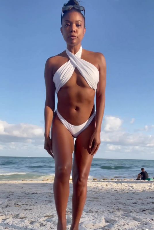 GABRIELLE UNION in a White Bikini at a Beach 12/04/2022