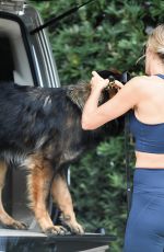 GISELE BUNDCHEN Out Jogging with Her Dog in Miami 02/08/2023