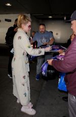 KATHRYN NEWTON Signs for Fans in Her Pajamas at LAX in Los Angeles 02/17/2023