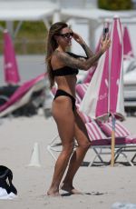 SOPHIA THOMALLA in a Black Bikini at a Beach in Miami 03/21/2023
